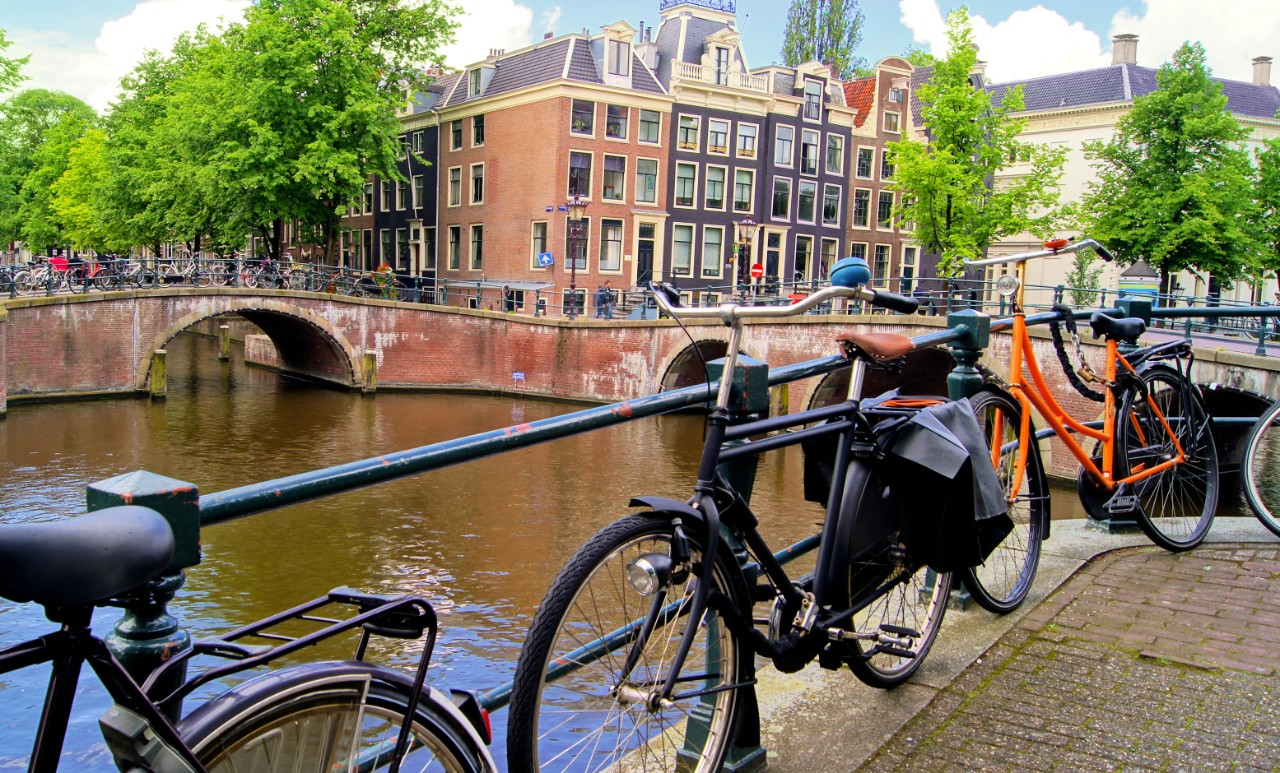 Amsterdam canal scence with bicycles and bridges